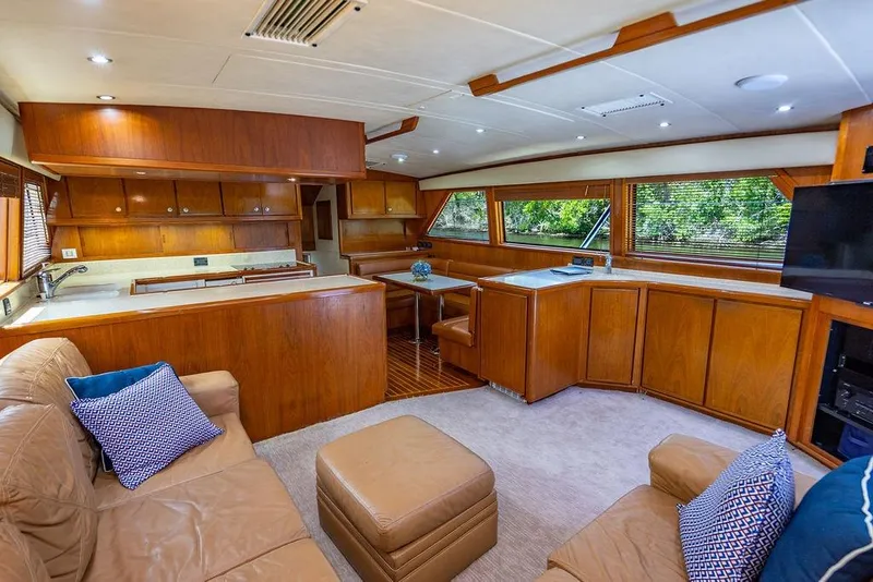 Slide: The Image of Luxurious interior of 1998 Bertram 60 Convertible yacht with wood finishes and plush seating. - 27
