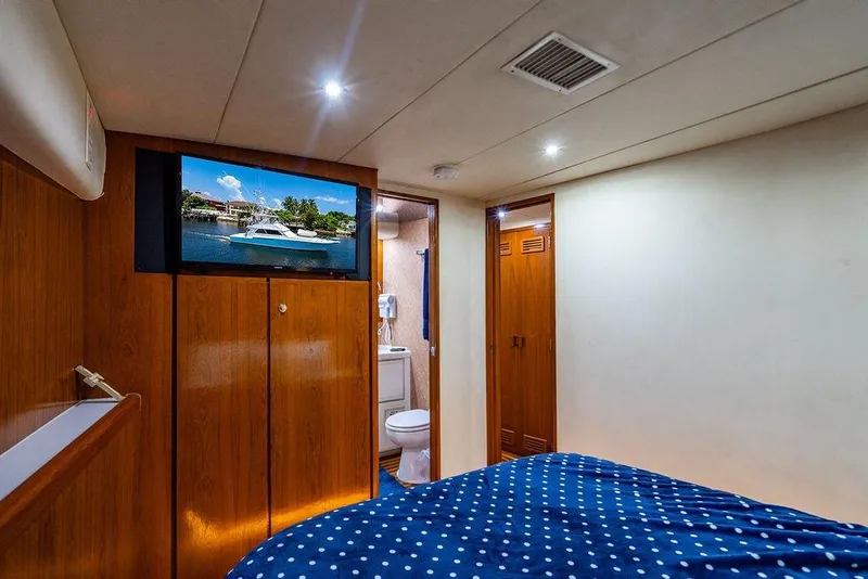Slide: The Image of Interior of 1998 Bertram 60 Convertible yacht with cozy bedroom and modern amenities. - 42