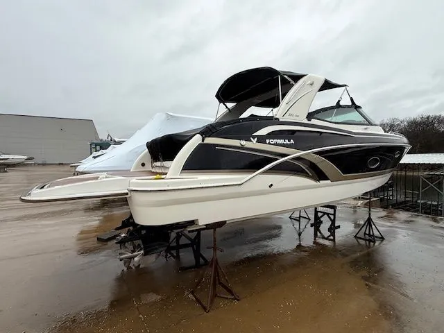 Slide: The Image of 2015 Formula 350 Crossover Bowrider on stands outdoors. - 1