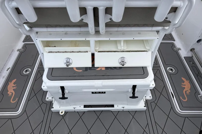 Slide: The Image of 2021 Sportsman Heritage 251 Center Console boat interior with storage compartments and cooler. - 10