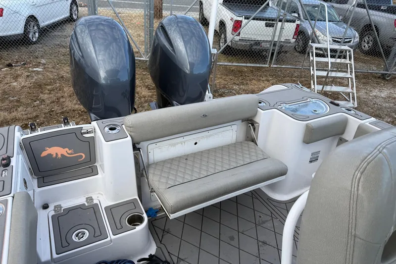 Slide: The Image of 2021 Sportsman Heritage 251 Center Console boat with dual engines and seating area. - 11