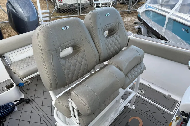 Slide: The Image of 2021 Sportsman Heritage 251 Center Console boat with cushioned seating and modern design. - 12