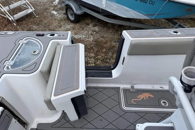 Slide: The Image of 2021 Sportsman Heritage 251 Center Console boat interior with seating and storage compartments. - 13