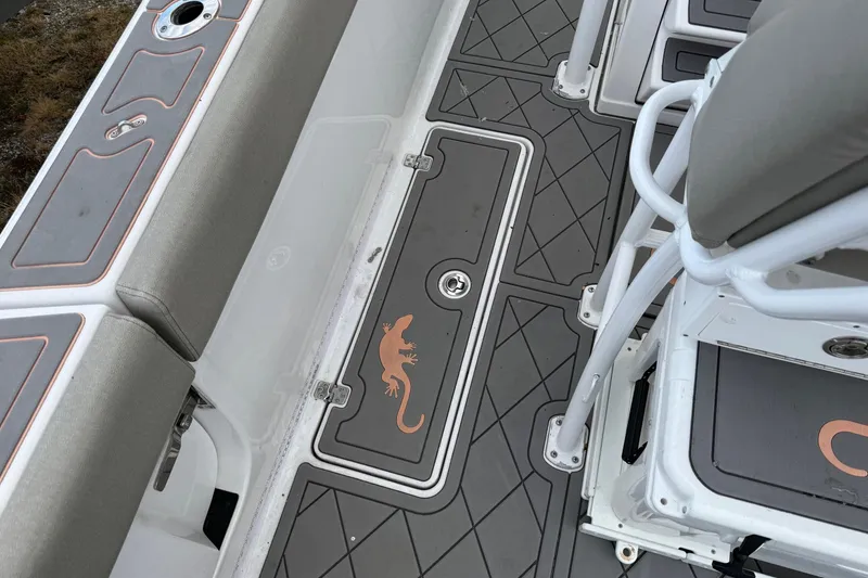 Slide: The Image of 2021 Sportsman Heritage 251 Center Console boat interior with lizard design on deck. - 8