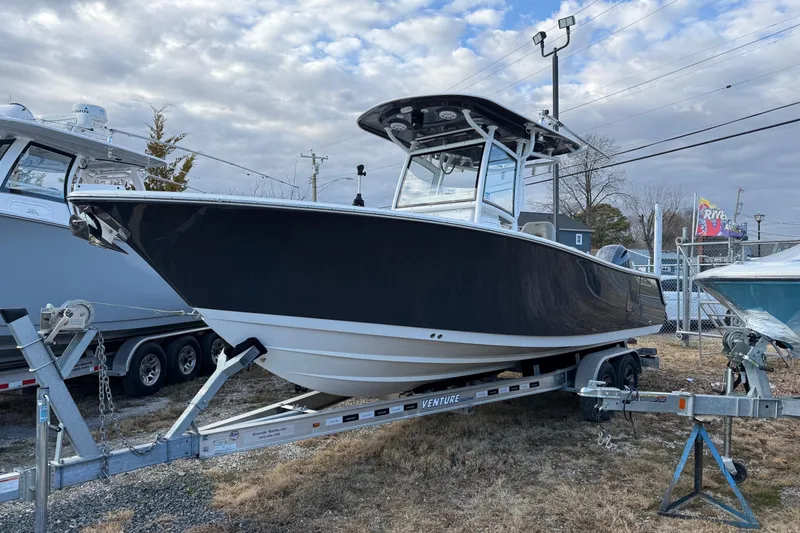 Slide: The Image of 2021 Sportsman Heritage 251 Center Console boat on trailer, outdoor display. - 1