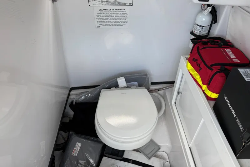 Slide: The Image of 2021 Sportsman Heritage 251 Center Console interior with toilet, fire extinguisher, and safety equipment. - 15