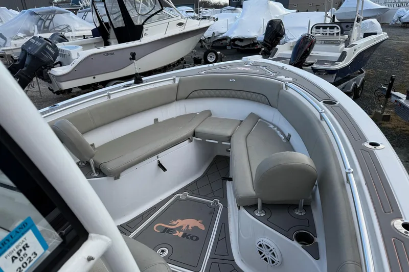 Slide: The Image of 2021 Sportsman Heritage 251 Center Console boat interior with cushioned seating and deck details. - 18