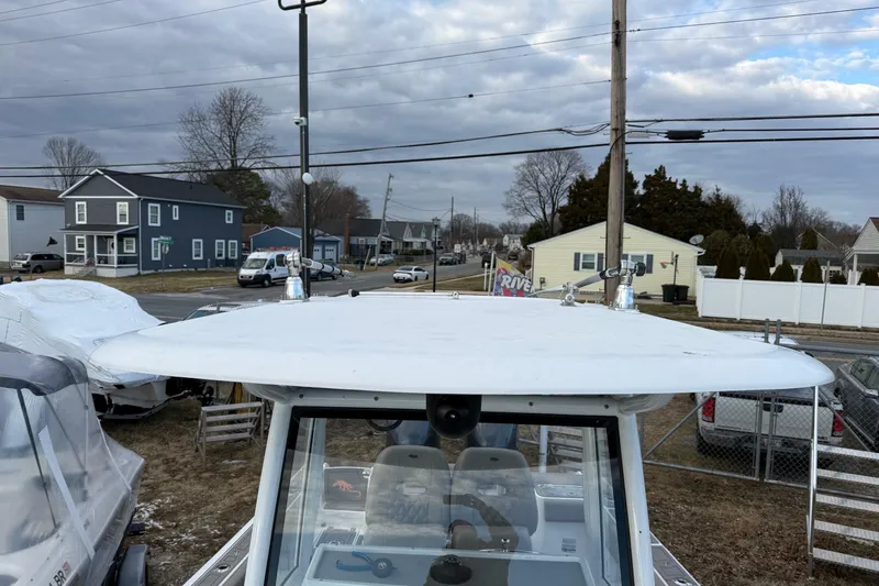 Slide: The Image of 2021 Sportsman Heritage 251 Center Console boat parked in a residential area. - 21