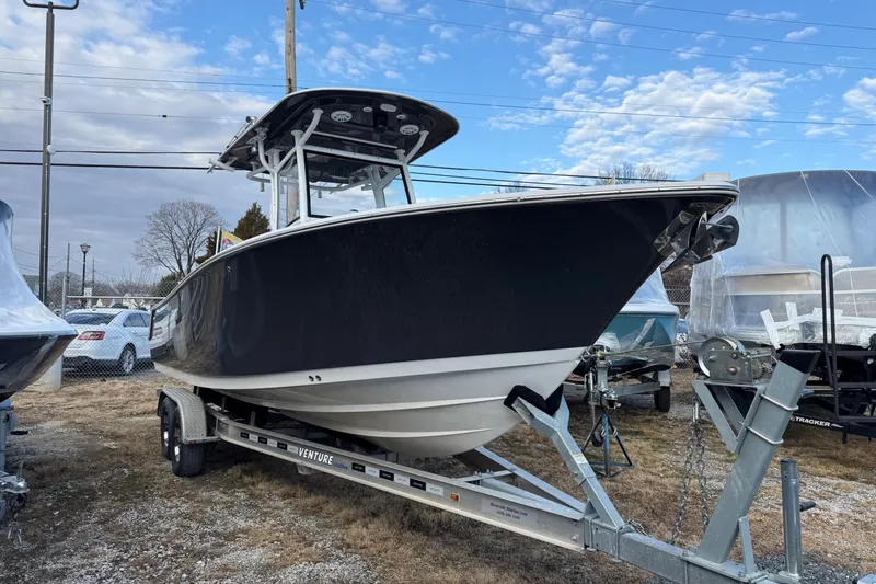 Slide: The Image of 2021 Sportsman Heritage 251 Center Console boat on trailer, parked outdoors. - 3