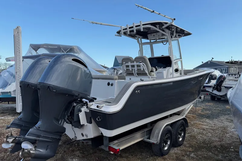 Slide: The Image of 2021 Sportsman Heritage 251 Center Console boat with dual engines on a trailer. - 4