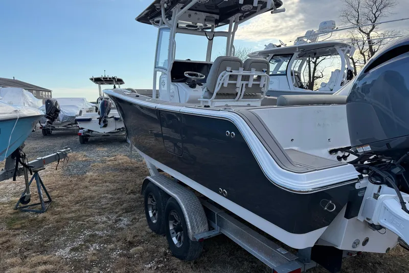 Slide: The Image of 2021 Sportsman Heritage 251 Center Console boat on trailer, parked outdoors. - 6