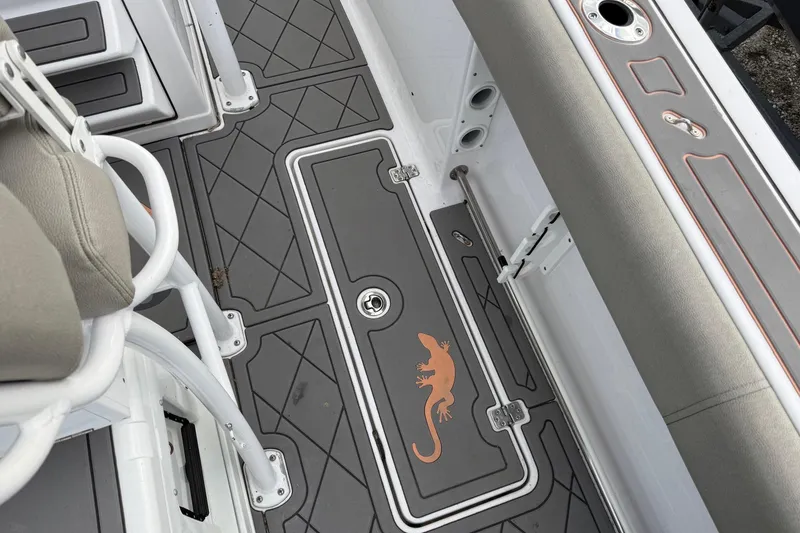Slide: The Image of 2021 Sportsman Heritage 251 Center Console boat deck with lizard design and cushioned seating. - 9