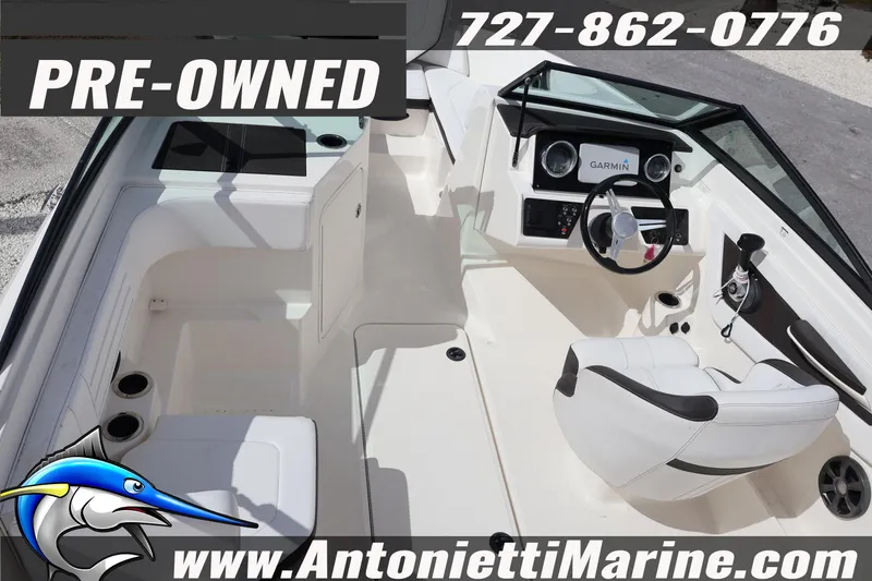 Slide: The Image of Pre-owned 2019 Sea Ray SPX 190 Outboard boat interior with steering console and seating. - 14