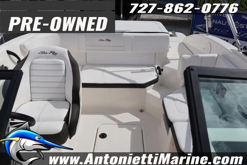Slide: The Image of Pre-owned 2019 Sea Ray SPX 190 Outboard boat interior with seating, contact details, and website. - 29
