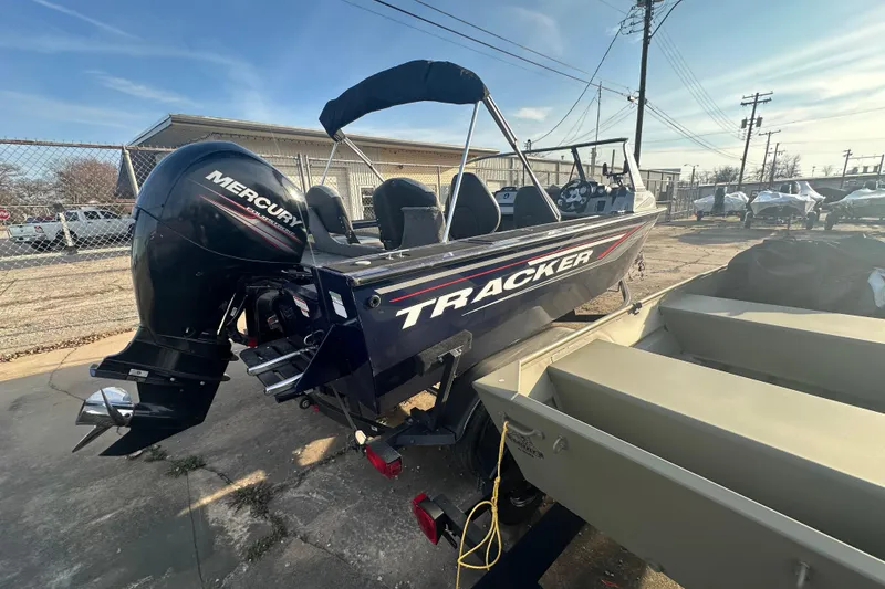 Slide: The Image of 2019 Tracker Targa V-18 Combo boat with Mercury outboard motor, parked outdoors. - 10