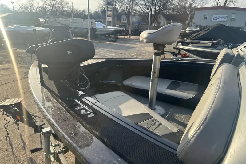 Slide: The Image of 2019 Tracker Targa V-18 Combo boat interior with seating and equipment, parked outdoors. - 3