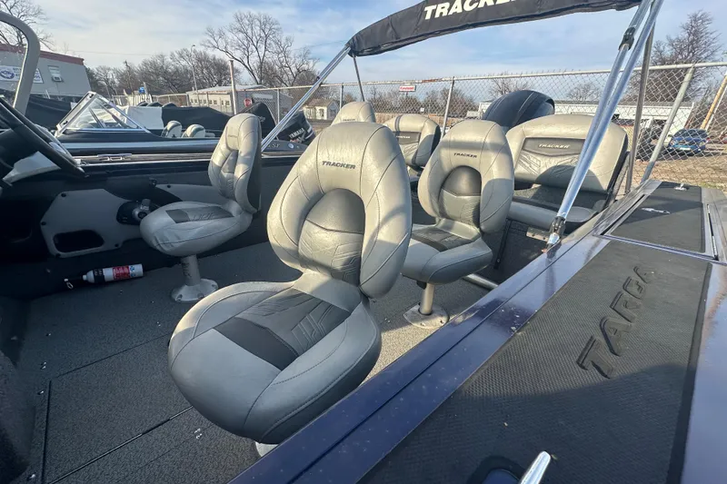 Slide: The Image of 2019 Tracker Targa V-18 Combo boat interior with gray seating and steering console. - 5