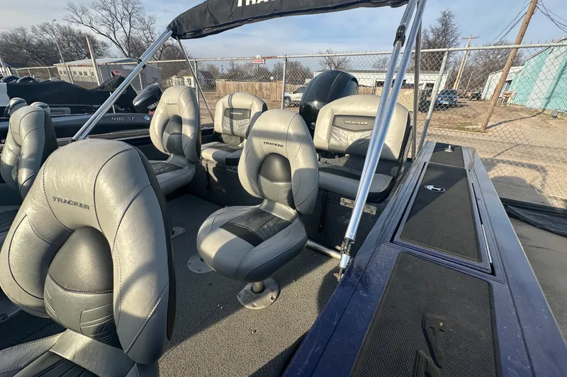 Slide: The Image of 2019 Tracker Targa V-18 Combo boat interior with gray seating and canopy. - 6