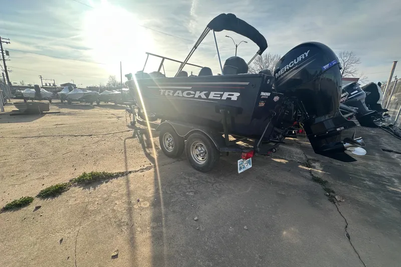 Slide: The Image of 2019 Tracker Targa V-18 Combo boat with Mercury engine in a sunlit outdoor setting. - 7