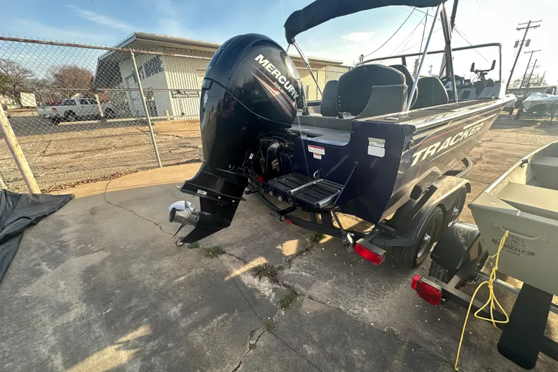 Slide: The Image of 2019 Tracker Targa V-18 Combo boat with Mercury outboard motor, parked on a trailer. - 9