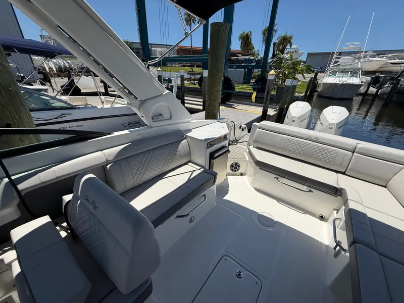 Slide: The Image of The image shows the cockpit of a Sea Ray SDX 290 Outboard with luxurious seating and twin outboard engines. - 15