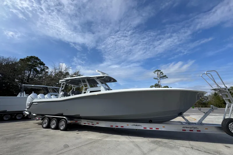 Slide: The Image of 2026 Invincible 43 Open Fisherman boat on trailer under blue sky. - 10