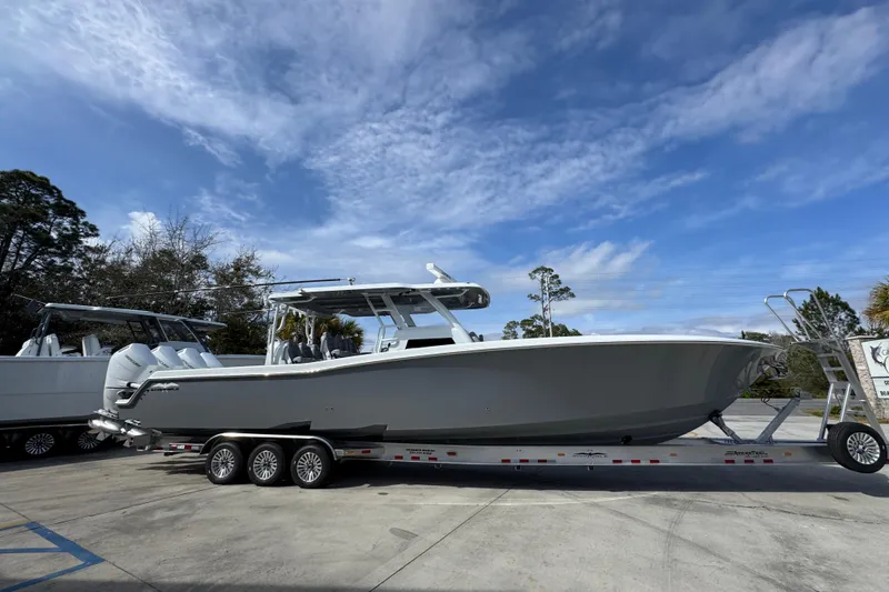 Slide: The Image of 2026 Invincible 43 Open Fisherman boat on trailer under blue sky. - 11