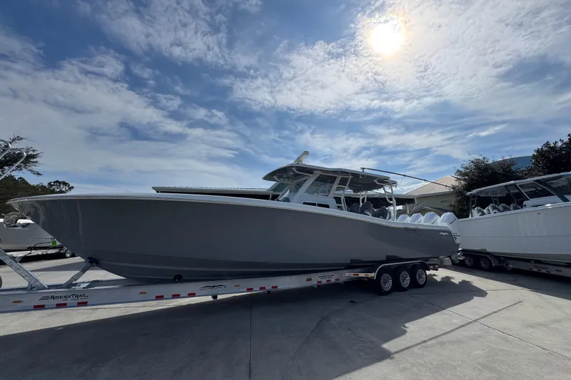 Slide: The Image of 2026 Invincible 43 Open Fisherman boat on trailer under sunny sky. - 2