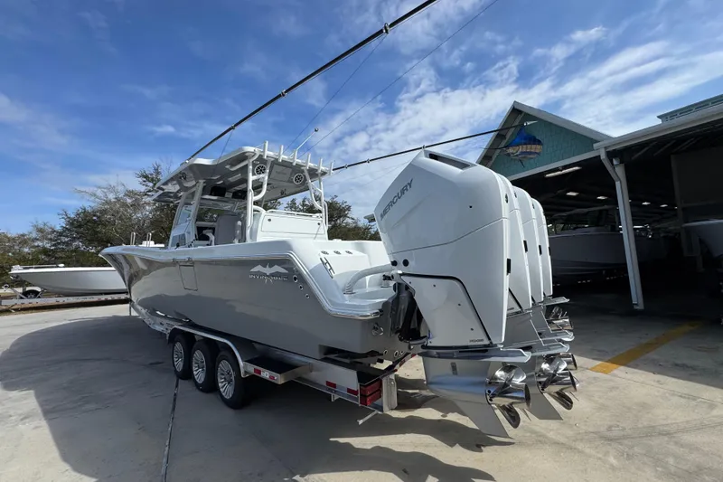 Slide: The Image of 2026 Invincible 43 Open Fisherman boat with triple Mercury engines on trailer. - 20