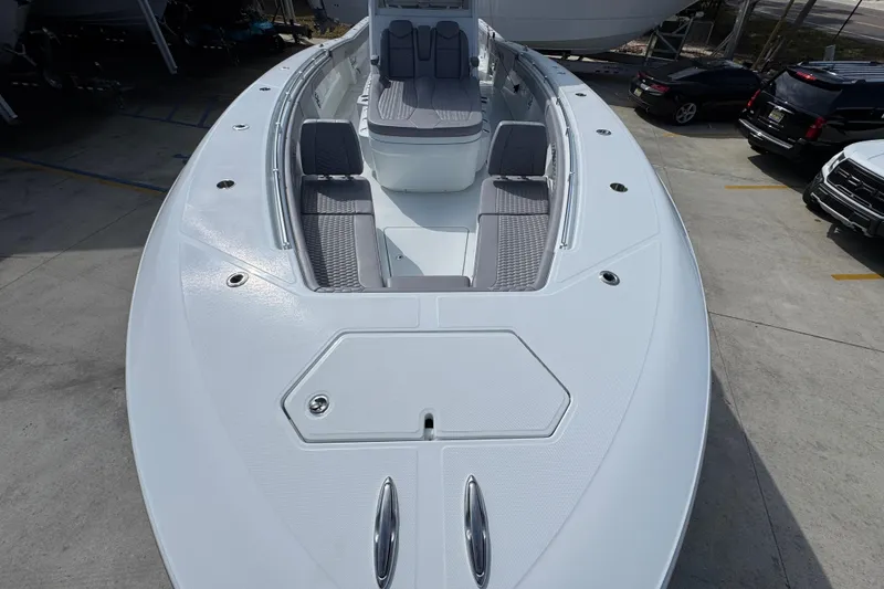 Slide: The Image of 2026 Invincible 43 Open Fisherman boat, spacious deck, sleek design, docked outdoors. - 22