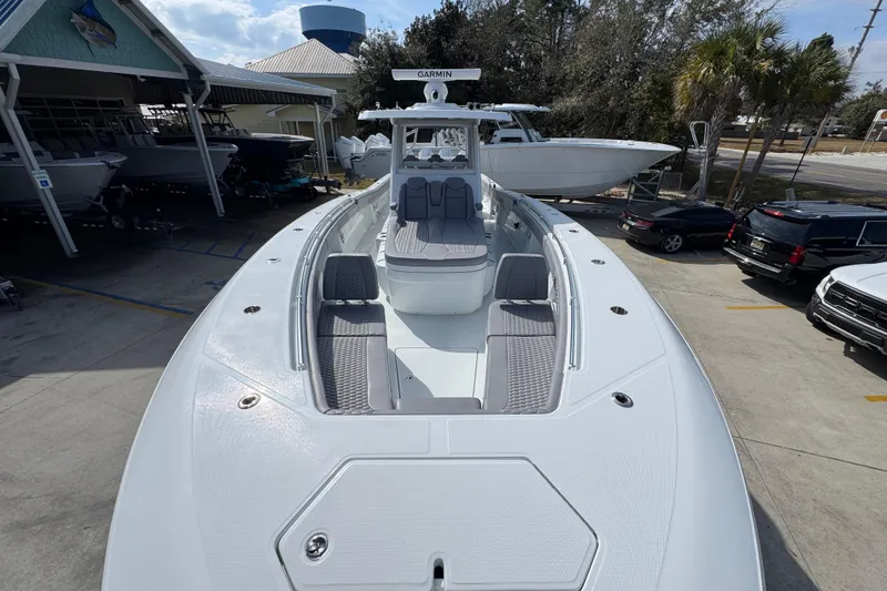 Slide: The Image of 2026 Invincible 43 Open Fisherman boat in marina, showcasing sleek design and spacious deck. - 23