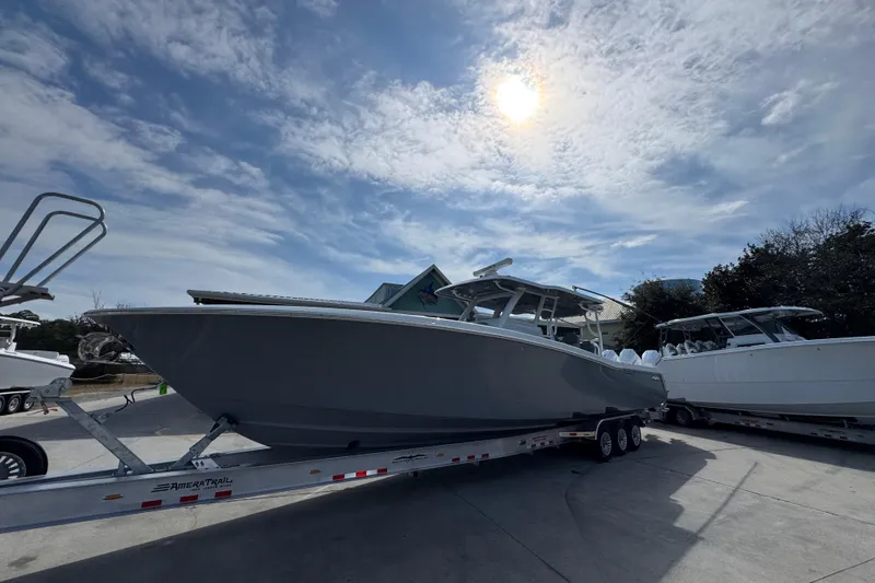 Slide: The Image of 2026 Invincible 43 Open Fisherman boat on trailer under cloudy sky. - 3