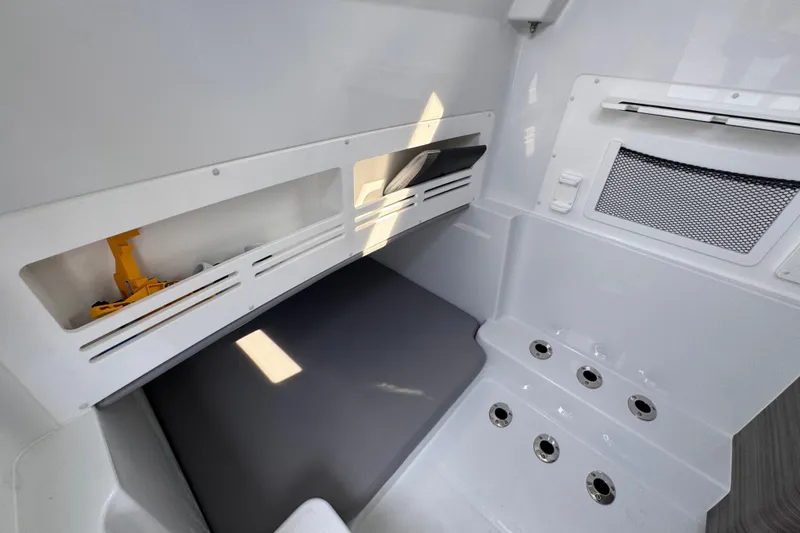 Slide: The Image of 2026 Invincible 43 Open Fisherman interior with storage compartments and seating area. - 33