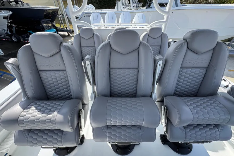 Slide: The Image of Luxurious seating on 2026 Invincible 43 Open Fisherman boat, featuring sleek gray upholstery. - 38