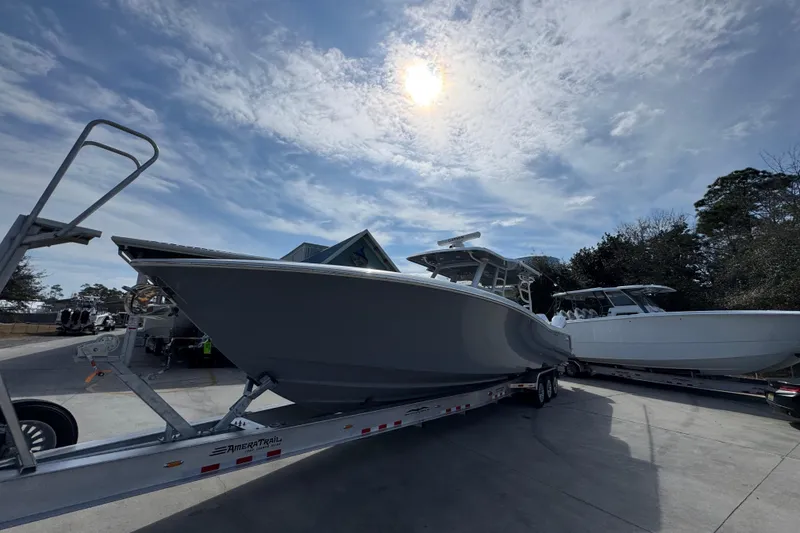 Slide: The Image of 2026 Invincible 43 Open Fisherman boat on trailer under sunny sky. - 4