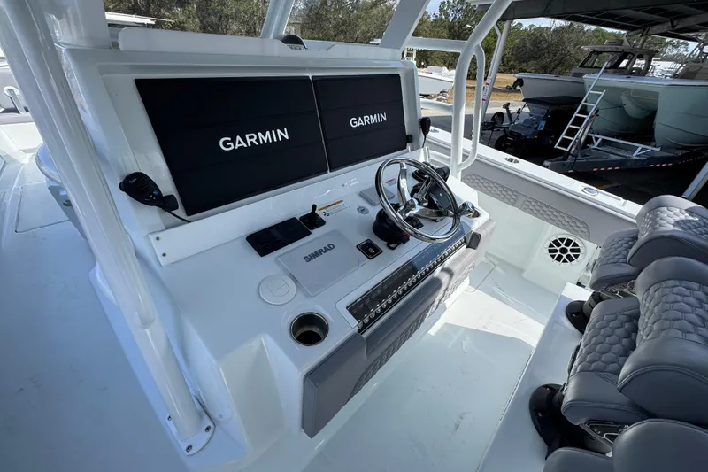 Slide: The Image of 2026 Invincible 43 Open Fisherman boat cockpit with Garmin displays and Simrad controls. - 42