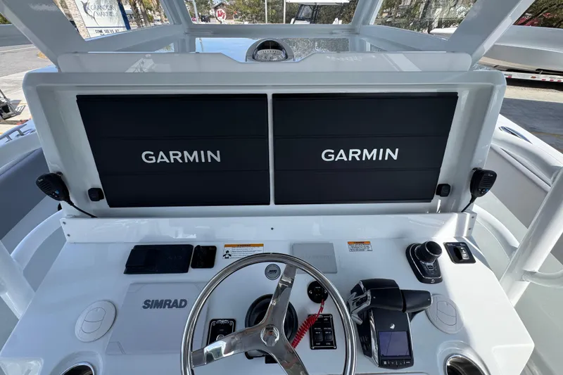 Slide: The Image of Helm of 2026 Invincible 43 Open Fisherman with Garmin displays and Simrad controls. - 44