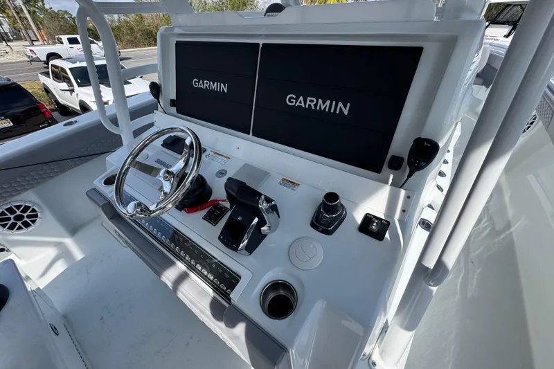 Slide: The Image of 2026 Invincible 43 Open Fisherman helm with dual Garmin displays and modern controls. - 46