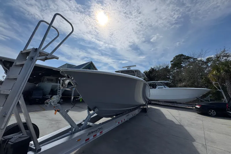 Slide: The Image of 2026 Invincible 43 Open Fisherman boat on trailer under sunny sky. - 5