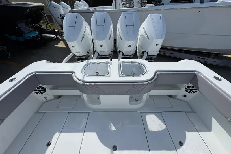 Slide: The Image of 2026 Invincible 43 Open Fisherman boat with four Mercury outboard engines. - 52