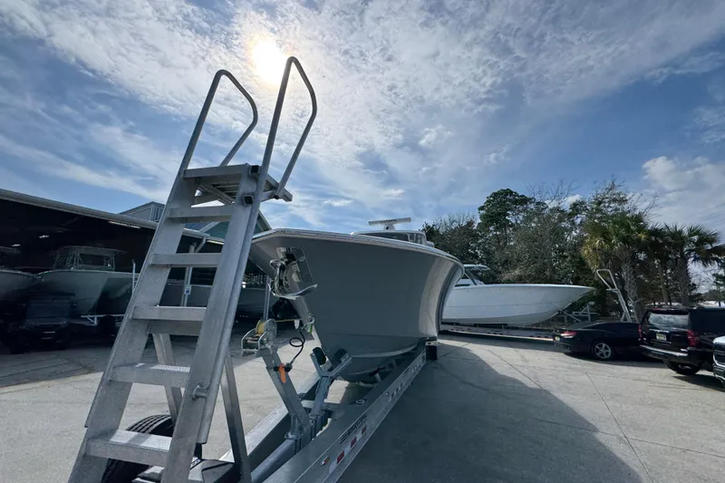 Slide: The Image of 2026 Invincible 43 Open Fisherman boat on trailer under sunny sky. - 6