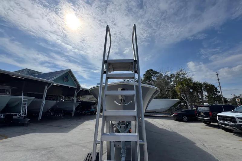 Slide: The Image of Ladder leading to Invincible 43 Open Fisherman boat, 2026 model, under a sunny sky. - 7