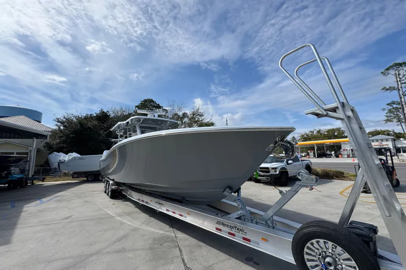 Slide: The Image of 2026 Invincible 43 Open Fisherman boat on trailer under blue sky. - 8
