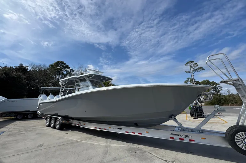 Slide: The Image of 2026 Invincible 43 Open Fisherman boat on trailer under blue sky. - 9