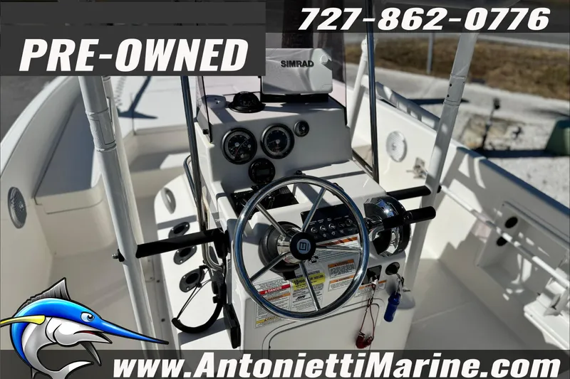 Slide: The Image of Pre-owned 2021 Bayliner Trophy T21Bay boat dashboard with steering wheel and controls. - 12