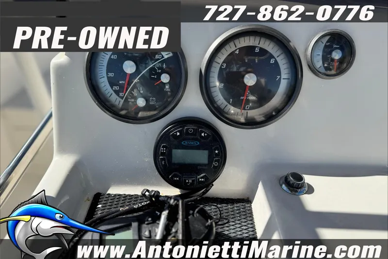 Slide: The Image of Pre-owned 2021 Bayliner Trophy T21Bay dashboard with gauges, contact info, and website. - 14