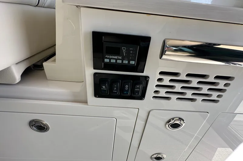 Slide: The Image of Control panel on 2021 Regal 36 XO boat, featuring Dometic system and switches. - 10
