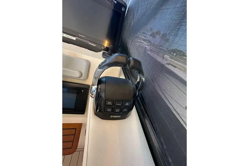 Slide: The Image of Yamaha throttle control on 2021 Regal 36 XO boat dashboard, featuring navigation equipment. - 19