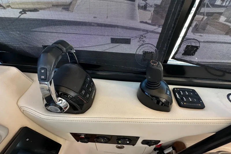 Slide: The Image of 2021 Regal 36 XO helm controls with joystick and throttle levers. - 20