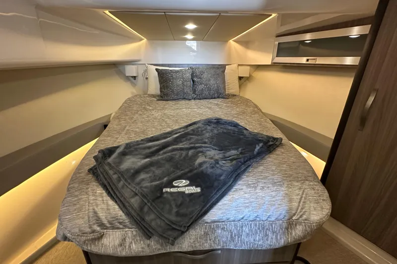 Slide: The Image of Luxurious cabin interior of 2021 Regal 36 XO yacht with cozy bedding. - 21